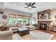 Cozy living room with a large sectional sofa, stone fireplace, and lots of natural light at 233 Hein Dr, Clayton, NC 27527