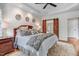 Serene primary bedroom with tray ceiling, barn door to ensuite bath, and hardwood floors at 233 Hein Dr, Clayton, NC 27527