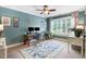 Bright home office featuring a large window, built-in shelving, and a stylish area rug at 233 Hein Dr, Clayton, NC 27527