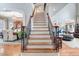 Grand staircase with wood treads and iron railings leads to the upper level of this stunning home at 233 Hein Dr, Clayton, NC 27527