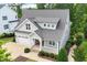An aerial shot showcases this well-manicured two-story home with manicured lawn and mature trees at 2409 Plowridge Rd, Fuquay Varina, NC 27526