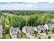 An aerial view showcases a neighborhood with green trees and lush landscaping around the homes at 2409 Plowridge Rd, Fuquay Varina, NC 27526