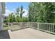 Spacious back deck with white railings, offering a beautiful view of the lush greenery at 2409 Plowridge Rd, Fuquay Varina, NC 27526