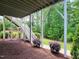 Landscaped backyard with stairs leading to the upper deck, complemented by lush trees and greenery at 2409 Plowridge Rd, Fuquay Varina, NC 27526