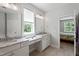 Well-lit bathroom with dual vanities, granite countertops, and a connecting bedroom view at 2409 Plowridge Rd, Fuquay Varina, NC 27526