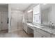 Modern bathroom with glass enclosed shower and double vanity sink with stone counters at 2409 Plowridge Rd, Fuquay Varina, NC 27526