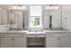 Bright bathroom featuring dual sinks, granite counters, and a central window at 2409 Plowridge Rd, Fuquay Varina, NC 27526