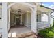 A covered front porch with a decorative light fixture provides an inviting entry to the home at 2409 Plowridge Rd, Fuquay Varina, NC 27526