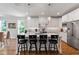White kitchen with granite island and counter tops. Stainless steel appliances with pendant lighting at 2409 Plowridge Rd, Fuquay Varina, NC 27526