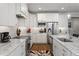 Spacious kitchen features stainless steel appliances, granite countertops, and ample white cabinetry at 2409 Plowridge Rd, Fuquay Varina, NC 27526
