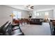 Cozy living room with plush sofas, a ceiling fan, and bright natural light at 2409 Plowridge Rd, Fuquay Varina, NC 27526