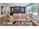 Contemporary living room with custom wall, large television, high-end speakers, and upscale furniture at 2409 Plowridge Rd, Fuquay Varina, NC 27526