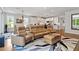 Open concept living area, adjacent dining, and sleek modern kitchen with granite countertops at 2409 Plowridge Rd, Fuquay Varina, NC 27526