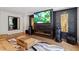 Beautiful living room featuring dark wood accent wall with modern fireplace and stylish decor at 2409 Plowridge Rd, Fuquay Varina, NC 27526