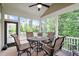 Inviting screened porch with a round table and chairs, perfect for enjoying the outdoors at 2409 Plowridge Rd, Fuquay Varina, NC 27526