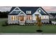 Charming two-story home featuring a stone facade, manicured lawn, and inviting front porch at 249 Lindo Johnson Rd, Pittsboro, NC 27312