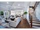 Sunlit living room showcasing hardwood floors, coffered ceilings, and staircase at 249 Lindo Johnson Rd, Pittsboro, NC 27312