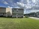 Backyard with green grass, a view of neighboring homes, and access to the street at 2612 Beagle Landing Dr, Raleigh, NC 27610