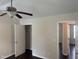 Bedroom featuring a ceiling fan, closet, neutral walls, and dark wood-look flooring at 2612 Beagle Landing Dr, Raleigh, NC 27610