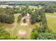 Expansive aerial view of a home nestled on a large lot surrounded by lush greenery and mature trees at 2712 Nc 57, Hillsborough, NC 27278