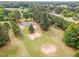An aerial shot of a home and property surrounded by trees, farmland, and verdant landscapes at 2712 Nc 57, Hillsborough, NC 27278