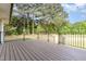 Spacious wooden deck with black metal railings, perfect for outdoor entertaining at 2712 Nc 57, Hillsborough, NC 27278