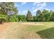 Expansive backyard with lush grass and large trees, perfect for outdoor activities at 2712 Nc 57, Hillsborough, NC 27278