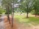 Large backyard with towering trees bordering the property, offering natural beauty and privacy at 2712 Nc 57, Hillsborough, NC 27278