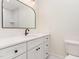 Well-lit bathroom vanity with a white marbled countertop, black hardware, and a stylish framed mirror at 2712 Nc 57, Hillsborough, NC 27278