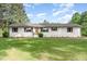Charming front exterior of home with freshly landscaped yard and white painted brick at 2712 Nc 57, Hillsborough, NC 27278