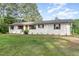 Charming front exterior of home with freshly landscaped yard and white painted brick at 2712 Nc 57, Hillsborough, NC 27278