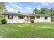 Charming front exterior of home with freshly landscaped yard and white painted brick at 2712 Nc 57, Hillsborough, NC 27278