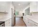 Open concept kitchen with stainless steel appliances and a view into the living area with fireplace at 2712 Nc 57, Hillsborough, NC 27278