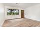 Bright living room featuring hardwood floors, trim work, and a large window with natural light at 2712 Nc 57, Hillsborough, NC 27278