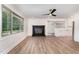 Open concept living room featuring a modern fireplace, large windows, and seamlessly connected with the kitchen at 2712 Nc 57, Hillsborough, NC 27278