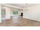 Open-concept living room with hardwood floors, fireplace, neutral paint and trim, and natural light at 2712 Nc 57, Hillsborough, NC 27278