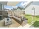 Cozy backyard with a modern outdoor sectional, fire pit, and well-maintained lawn, perfect for entertaining at 277 Douglas Falls Dr, Wendell, NC 27591