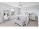 Bright bedroom featuring a large window, ceiling fan, and full length mirror at 277 Douglas Falls Dr, Wendell, NC 27591
