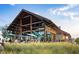 Modern community clubhouse with outdoor dining and a timber frame great for socializing at 277 Douglas Falls Dr, Wendell, NC 27591