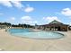 Resort-style community pool featuring ample seating, splash fountain and covered patio in a Gathering friendly neighborhood at 277 Douglas Falls Dr, Wendell, NC 27591
