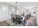 Dining room featuring a dark wood table and upholstered chairs leading to the kitchen at 277 Douglas Falls Dr, Wendell, NC 27591