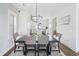 Dining room featuring a dark wood table and upholstered chairs leading to the kitchen at 277 Douglas Falls Dr, Wendell, NC 27591