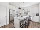 Bright kitchen with white cabinetry, stainless steel appliances, and a center island with seating at 277 Douglas Falls Dr, Wendell, NC 27591