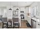 Bright kitchen with white cabinetry, stainless steel appliances, and a center island with seating at 277 Douglas Falls Dr, Wendell, NC 27591