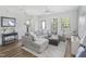 Bright living room with stylish gray sectional sofa, white walls, and lots of natural light at 277 Douglas Falls Dr, Wendell, NC 27591
