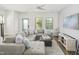 Spacious living room featuring a plush sectional sofa, stylish decor, and bright windows at 277 Douglas Falls Dr, Wendell, NC 27591