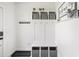 A well-organized mudroom with built-in storage, hooks, and a bench for convenient entry at 277 Douglas Falls Dr, Wendell, NC 27591