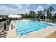 Large pool with marked lanes, slide, splash buckets, lounge seating, and mature trees at 277 Douglas Falls Dr, Wendell, NC 27591