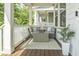 Relaxing outdoor porch seating area with cushioned furniture and neutral rug at 277 Douglas Falls Dr, Wendell, NC 27591