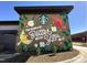 Vibrant mural on exterior of local Starbucks, creating a community space for residents at 277 Douglas Falls Dr, Wendell, NC 27591